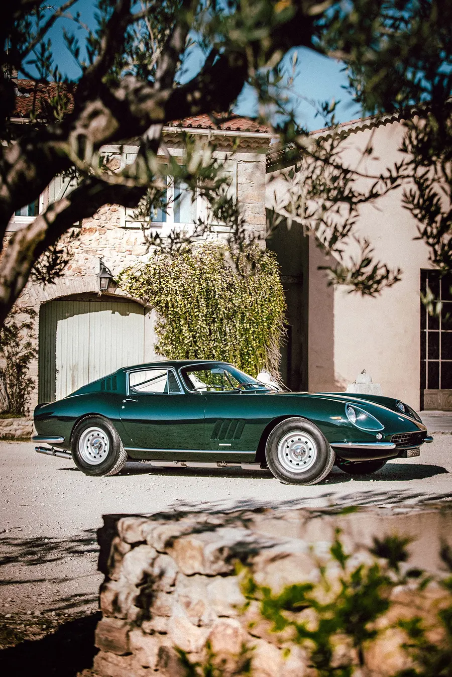Green Ferrari 275 GTB photographed from a low angle