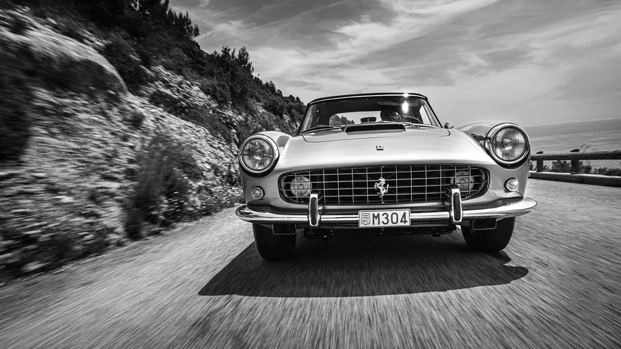 Classic Ferrari 250 GT parked in natural light, showcasing its elegant coachwork
