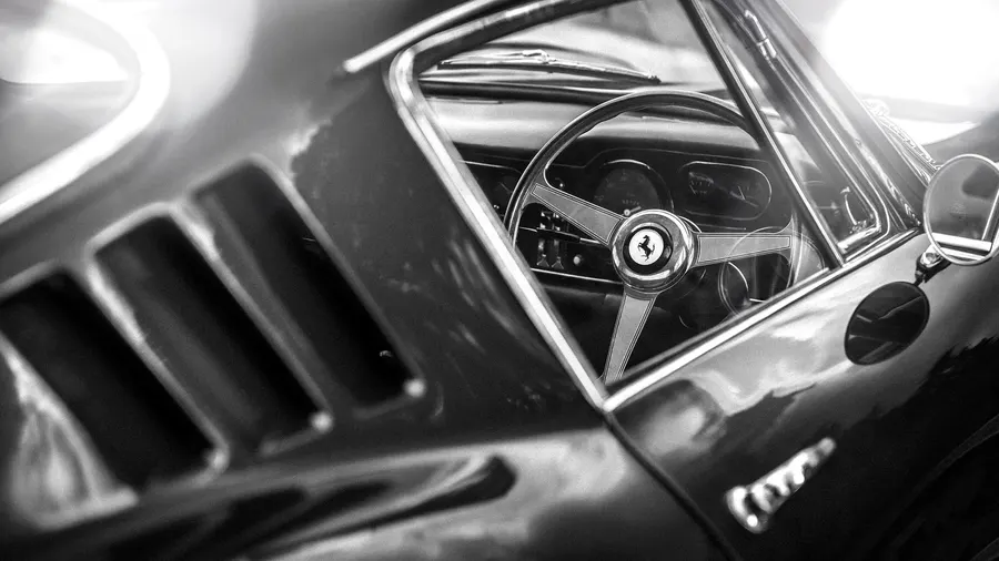 Close-up of a Ferrari 275 GTB's steering wheel and cockpit details