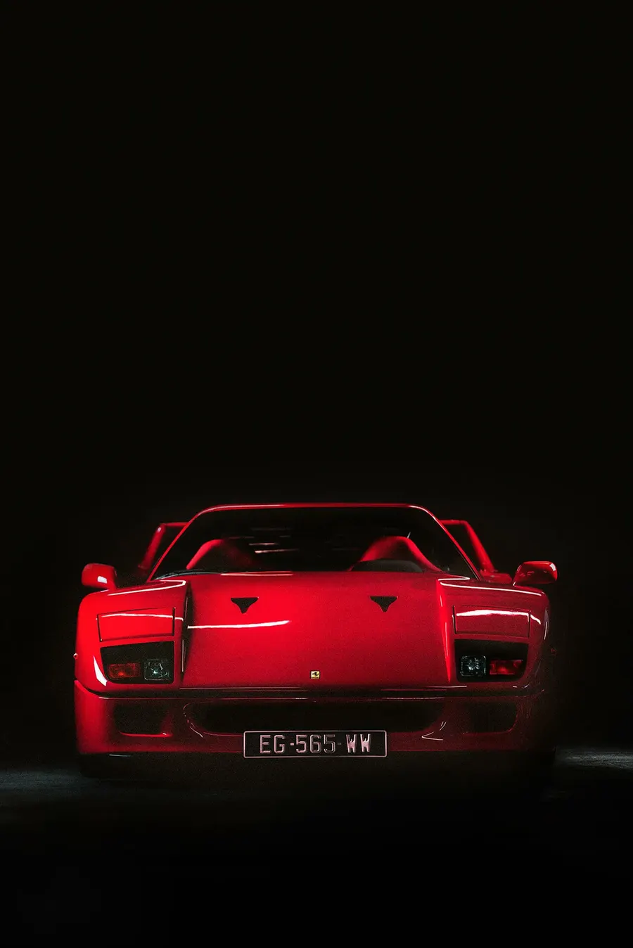 Ferrari F40 parked in dramatic light, showcasing its iconic silhouette